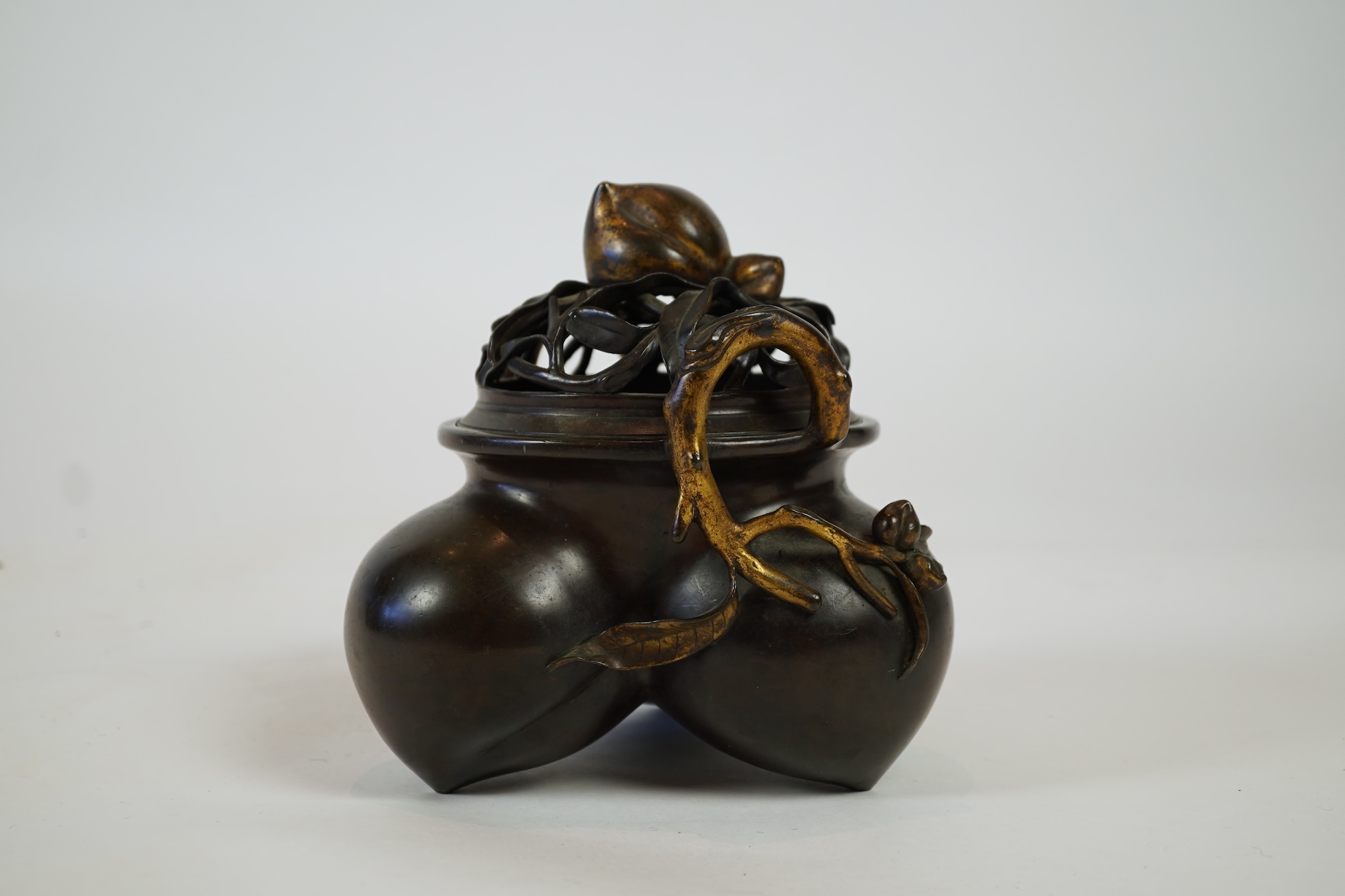 A large Chinese bronze and parcel gilt ‘peach’ censer and cover, Li, 17th/18th century